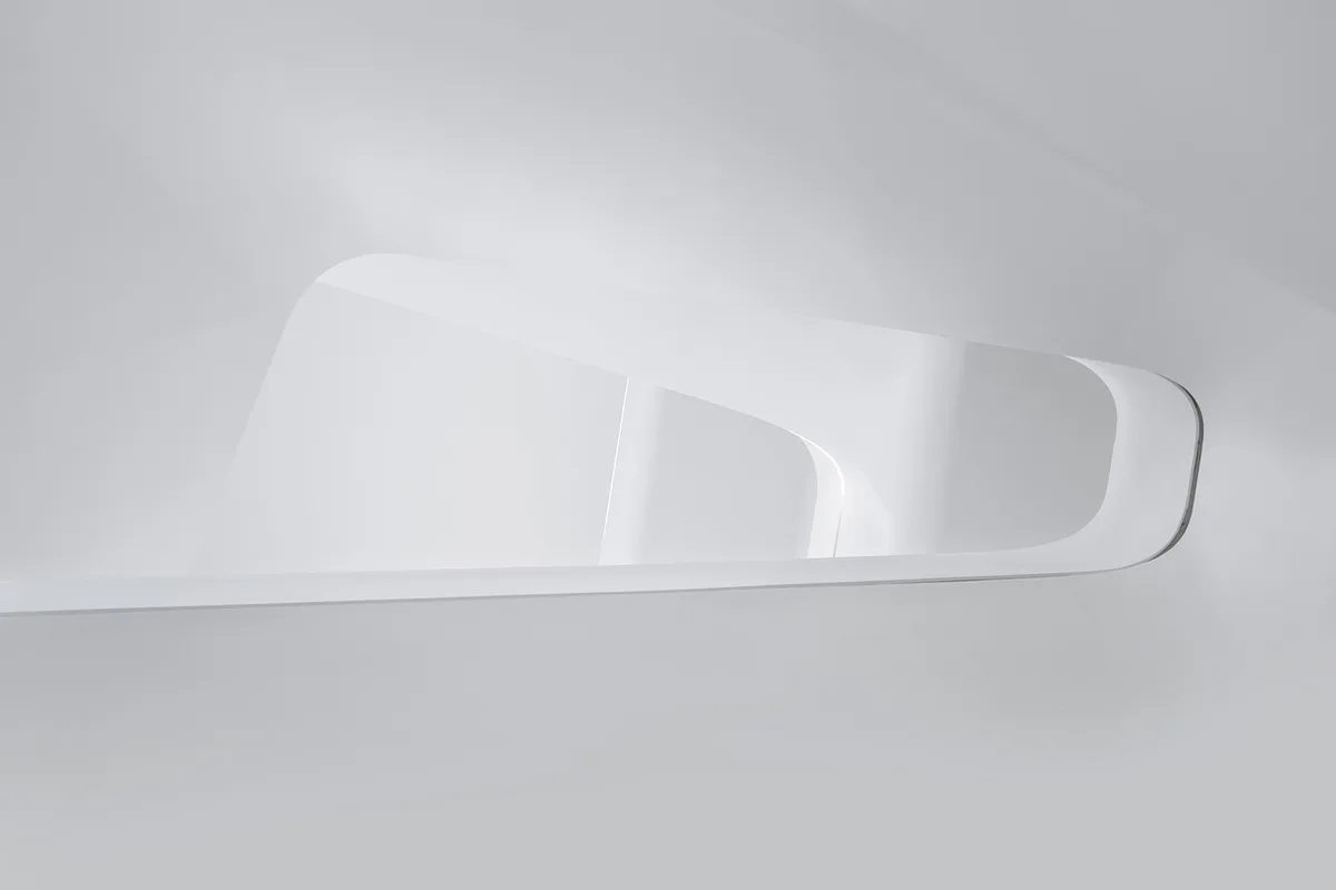 a painter applying smoothing compound with a wide stainless steel spatula on a textured interior wall