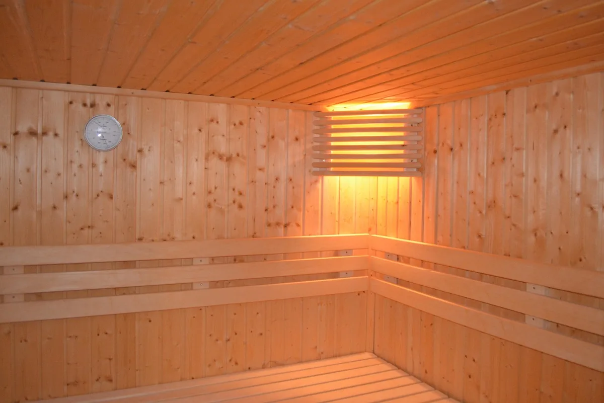 Interior wooden bench corner with sauna paneling, bright